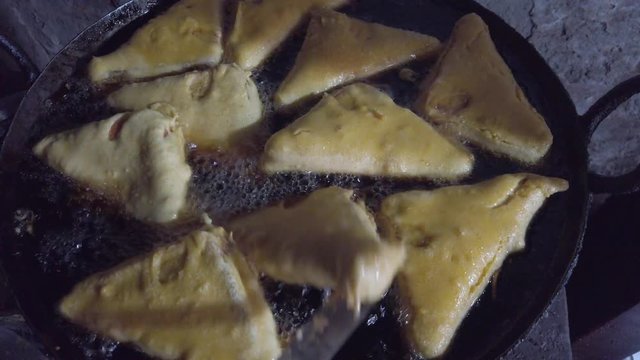 Close-up of popular snack of bread pakora stuffed with spiced mashed potatoes. a favorite breakfast and tea or chai time snack in Indian subcontinent. slow motion Handheld stabilized gimbal 4k