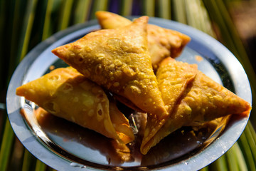 Vegetarian samosas, Indian special traditional street food. Indian stuffed snacks Samosa on metal plate, close up.