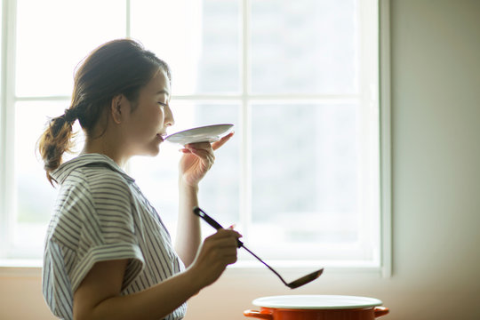 料理の味見をする20代女性の横顔