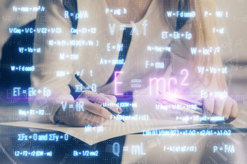 Science formula hologram over woman's hands taking notes background. Concept of study. Multi exposure