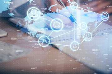 Social network theme hologram over hands taking notes background. Concept of global international people connect. Double exposure