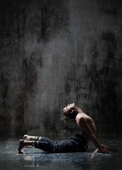 Obraz na płótnie Canvas Young beautiful yoga instructor is posing in studio.