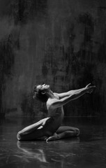 Young beautiful yoga instructor is posing in studio.