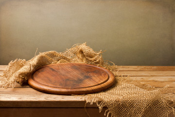 Wooden board on a wooden table on grunge abstract background