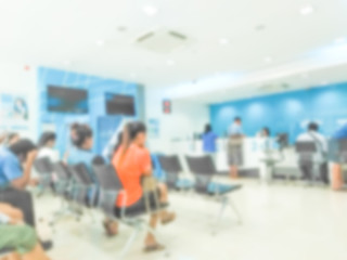 blur background of people sit down wait bank teller cashier counter in office building lobby for background