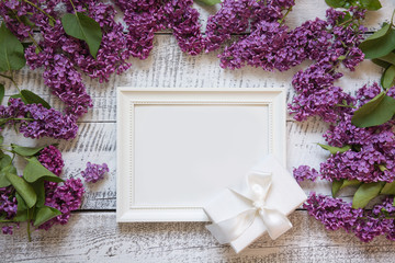 Bordr of purple lilac flowers and white frame for text and invitation. View from above.