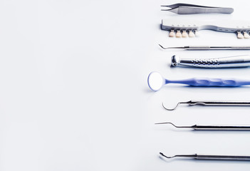 Dentistry instruments on white background with copy space