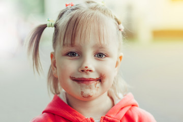 Adorable little girl eating chocolate ice cream outdoors in park. Childhood, lifestyle, summer time concept