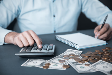 man hand money with calculator and notepad