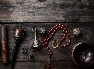 Copper singing bowl, prayer beads, prayer drum and other Tibetan religious objects for meditation...