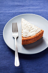 Homemade cheesecake with cream on a plate