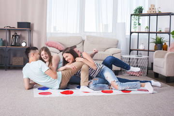 Group of friends having fun at home. People playing home games. Leisure. Friends together indoors...