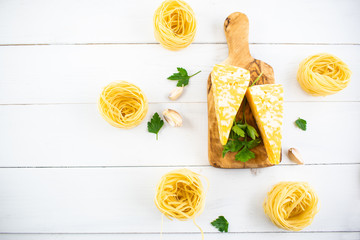 various types of pasta on a white wooden table. Italian cuisine concept, food ingredients. Flat lay. Top view
