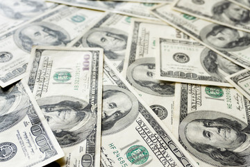 Fototapeta premium Pile of old one hundred dollar bills bills, close up dollars