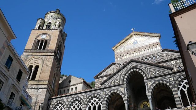 Amalfi, Salerno, Campania, Italy, Europe - may 19 2019: Amalfi Cathedral decorated with mosaics with Ziro Tower on background. Tourists in the summer on Amalfi Coast