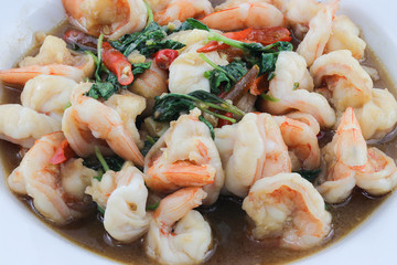 rice topped with stir-fried squid and basil isolated on white background