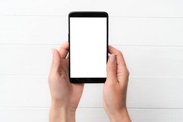Black smartphone mockup in hand for your design on white table background