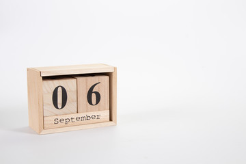 Wooden calendar September 06 on a white background