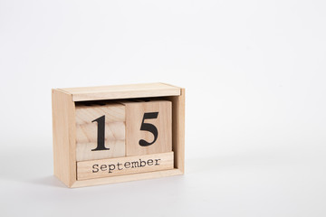 Wooden calendar September 15 on a white background