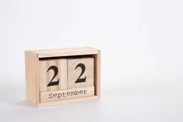 Wooden calendar September 22 on a white background