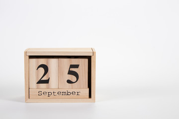 Wooden calendar September 25 on a white background