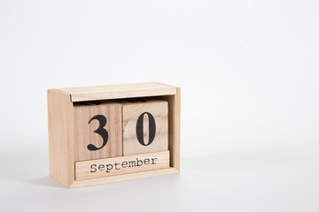 Wooden calendar September 30 on a white background