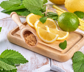 ripe yellow lemons and lime, brown sugar and a bunch of fresh mint