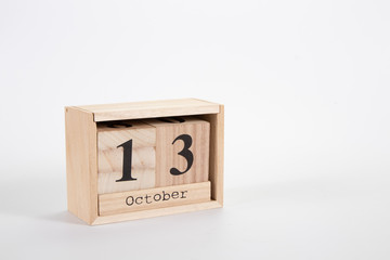 Wooden calendar October 13 on a white background