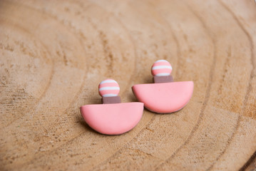 Fototapeta na wymiar Handamde minimalist geometric stud earrings. Fashion pink geometric jewelry.