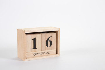 Wooden calendar October 16 on a white background