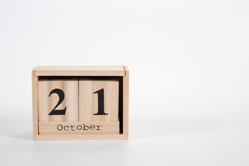 Wooden calendar October 21 on a white background