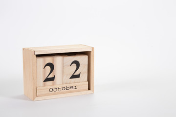 Wooden calendar October 22 on a white background