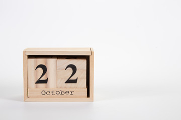 Wooden calendar October 22 on a white background