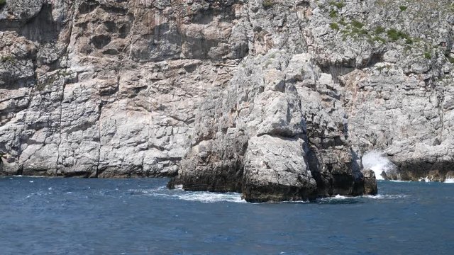 Positano, Salerno, Campania, Italy, Europe: rock on the Amalfi Coast seen from the sea on a boat that sways