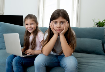 Young little girl using laptop ignoring her angry sad lonely old