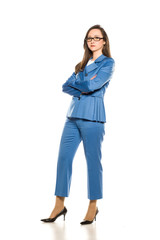 Young serious business woman with crossed arms standing on white background