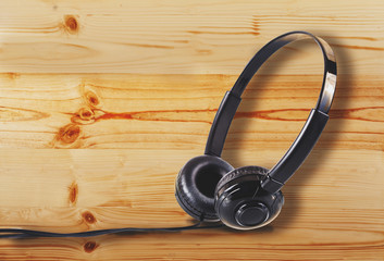 Headphone on Pine wood floor or desktop table background.