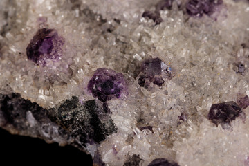 macro mineral fluorite stone on black background