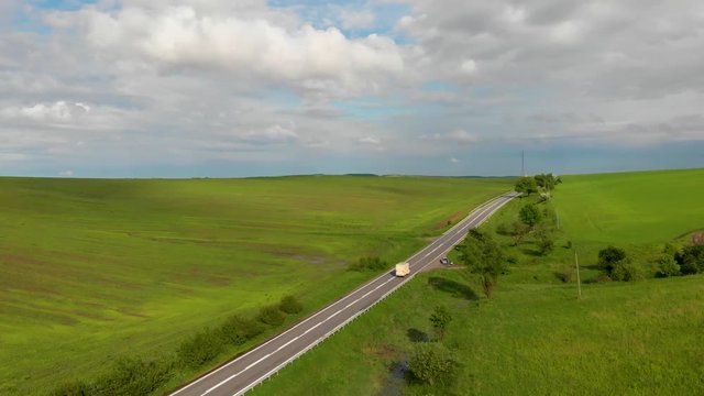 white truck ride along the road near large beautiful fields with green wheat aerial background nature wallpapper