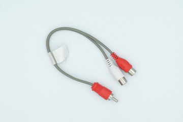 This is a capture for a red and white RCA cable on a white background and a studio light