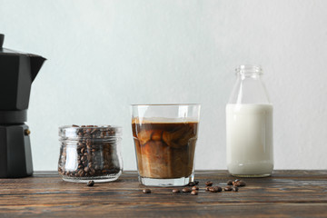 Coffee time accessories on wooden table against light background, space for text