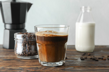 Coffee time accessories on wooden table against light background, space for text