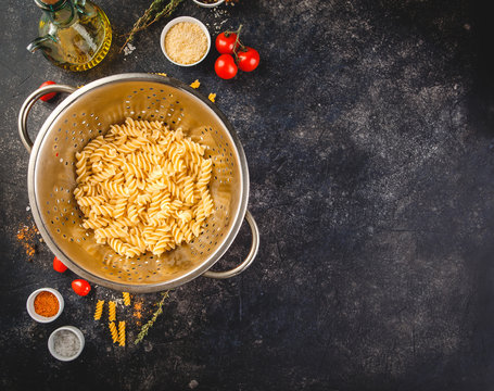 Fusilli pasta in a stainless steel colander