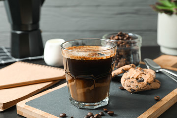 Coffee time accessories on black table against grey background, space for text. Break time