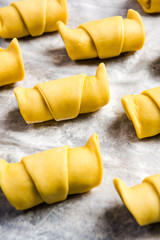 French pastry croissants or rolls ready to bake on baking tray