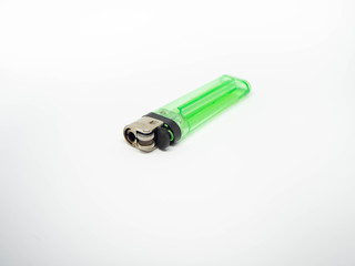 Green plastic gas lighter. Gas lighter isolated on white background. Closeup shot, top view