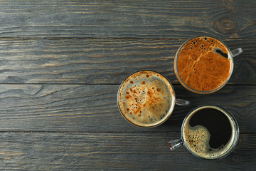 Cups of coffee on wooden background, space for text and top view