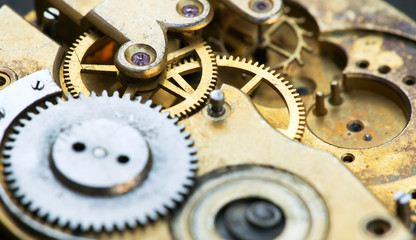 Gears of a vintage metal business clock watch close-up, time mechanism web banner