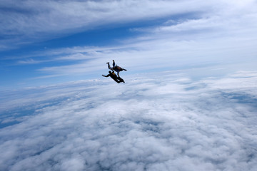 Fototapeta na wymiar Skydiving. Two guys are in the sky.