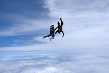 Skydiving. Two guys are in the sky.